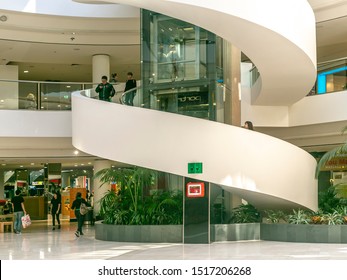 CANBERRA, AUSTRALIA – September 29, 2019: View Of People Using The Spiral Stairway And Glass Elevator In Westfield Belconnen Shopping Centre In Canberra, The Australian Capital Territory