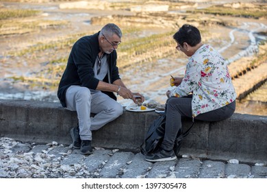 Cancale, France - September 13, 2018: Couple Eating Oysters Bought On The Seafront At Cancale, Brittany, France