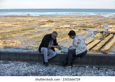 Cancale, France - September 13, 2018: Couple Eating Oysters Bought On The Seafront At Cancale, Brittany, France