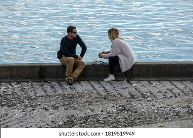 Cancale, France - September 15, 2018: Couple Eating Oysters Bought On The Seafront At Cancale, Brittany, France