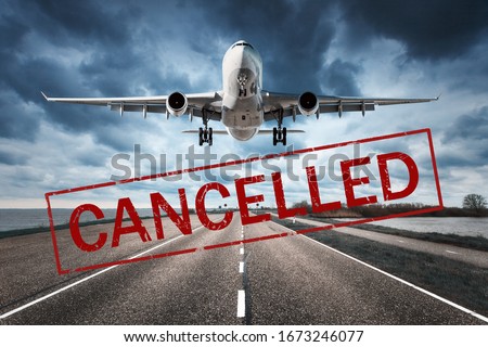 Canceled flights in Europe and USA airports. Travel vacations cancelled because of pandemic of coronavirus. Flying passenger airplane and runway. Flight cancellation. Aircraft with text. Covid-19 ストックフォト © 