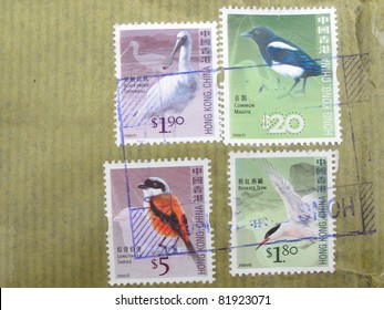 Canceled postage stamps with package wrapper from Hong Kong