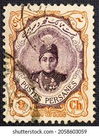 Cancelled postage stamp printed by Persia, that shows Ahmad Shah Qajar in an ornament frame, circa 1922.
