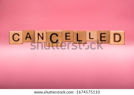 CANCELLED word made with building blocks, business concept. Word CANCELLED on pink background. Global mass gathering cancelled. Cancelled background, Plan changing.