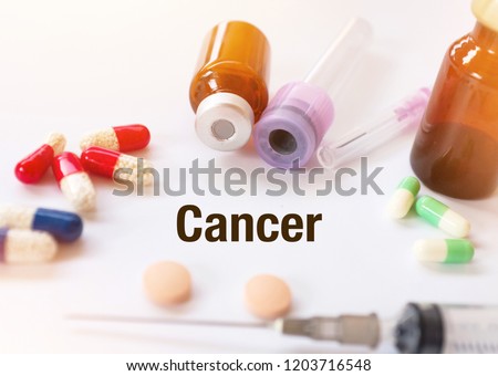 Cancer -Diagnosis written on a white piece of paper. Treatment and prevention of disease. Syringe and vaccine with drugs. Medical and Healthcare concept. Selective  focus