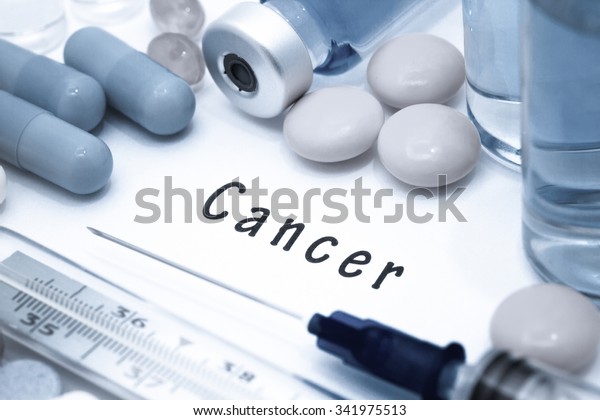 Cancer - diagnosis written on a white piece\
of paper. Syringe and vaccine with\
drugs.
