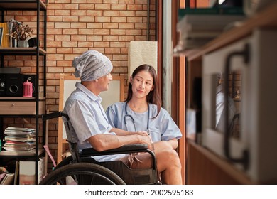 Cancer Elderly Patients In Wheelchairs Receive Rehabilitation Treatment In Private Home, Asian Female Doctor Medical Therapy Treatments By Talking To Cure Loneliness And Encourage Them With A Smile.