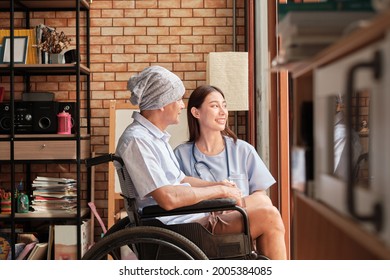 Cancer Elderly Patients In Wheelchairs Receive Rehabilitation Treatment In Private Home, Asian Female Doctor Medical Therapy Treatments By Talking To Cure Loneliness And Encourage Them With A Smile. 