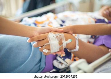 Cancer Patients Are Encouraged By Family Members With Joyful Handshaking In A Hospital.