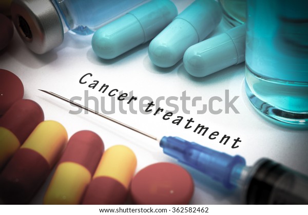 Cancer treatment - diagnosis\
written on a white piece of paper. Syringe and vaccine with\
drugs.