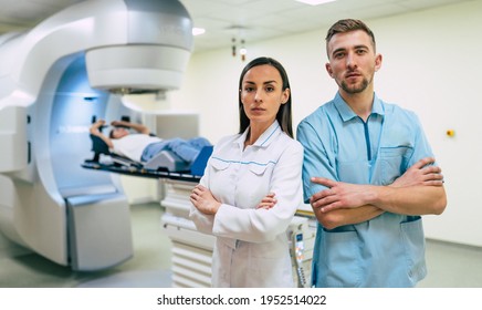 Cancer Treatment In A Modern Medical Private Clinic Or Hospital With A Linear Accelerator. Professional Doctors Team Working While The Woman Is Undergoing Radiation Therapy For Cancer