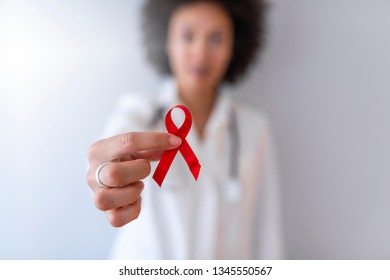 Cancer woman awareness medical stick ribbon for healthcare with stethoscope. AID, HIV red ribbon. Symbol of awareness, charity, support in disease, illness, ill. Medical health care, help and hope. 