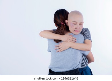 Cancer Woman With No Hair Hug Her Friends Or Family To Receive Warm, Love, Care And Will To Fgiht With Her Severe Diesease On White Backgroun With Copy Space/ Medial And Care Concept