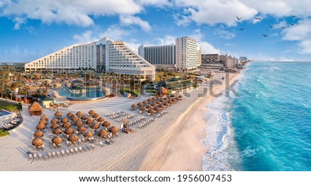 Cancun beach with resorts near blue ocean