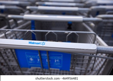 Cancun, Mexico - 9 February 2016: Shopping cart near Walmart supermarket. Closeup on shop trolley with sign Walmart