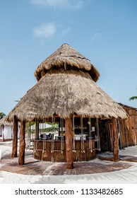 CANCUN, MEXICO - July 13, 2018: A Palm Frond Palapa Style Beach Bar With Swings As Seats