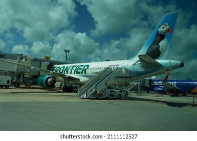 CANCUN, MEXICO - JULY 3, 2021: Frontier Airlines plane on tarmac at Cancun International Airport. Frontier Airlines is an American ultra low-cost carrier headquartered in Denver, Colorado.