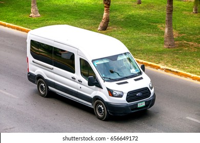 CANCUN, MEXICO - JUNE 3, 2017: White van Ford Transit in the city street.