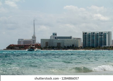 Cancun, Mexico - March 16 2015: 
Catamaran On The Background Of Skyscrapers In Cancun