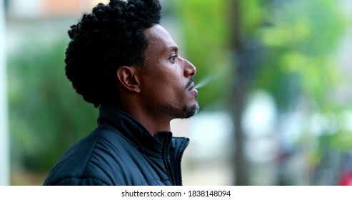 Candid African American Smoking Cigarette Outside