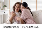 Candid attractive beautiful mum sit at cozy sofa couch living room in family moment grown child kid celebrate joy good warm time kiss relationship with retired overjoy lady girl health life insurance.