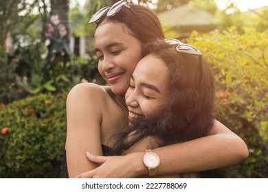 Candid blissful scene of two best friends hugging each other. Appreciating and cherishing their long years of friendship.