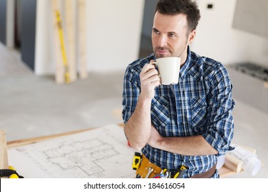 Candid construction worker relaxing with cup of coffee - Powered by Shutterstock