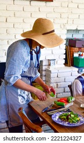 Candid Family Photo Of A Woman Cutting Vegetables For Dinner 