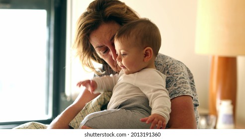 Candid grandmother holding baby grandson. Casual grand-parent grand-child in morning - Powered by Shutterstock