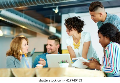 Candid Image Of A Group With Succesful Business People Caught In An Animated Brainstorming Meeting