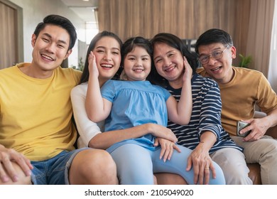 Candid Laugh Family Cuddle Together,asian Multi Generation Family Visiting Together With Grand Parent After Lockdown Is Over,asian Family Look At Camera Hugging Together With Love And Relationship