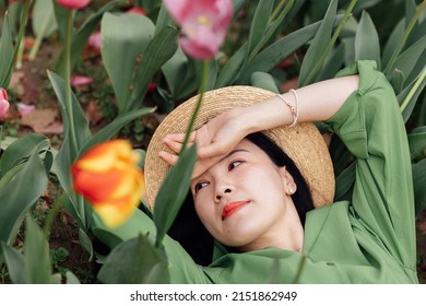 Candid Lifestyle Portrait Of Happy Young Beautiful Asian Sexy Woman Enjoying Life Outdoor In Park At Spring. Smiling Millennial Girl With Perfect Clear Glow Skin And Long Brunette Hair