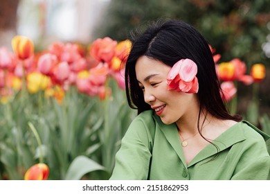 Candid Lifestyle Portrait Of Happy Young Beautiful Asian Sexy Woman Enjoying Life Outdoor In Park At Spring. Smiling Millennial Girl With Perfect Clear Glow Skin And Long Brunette Hair