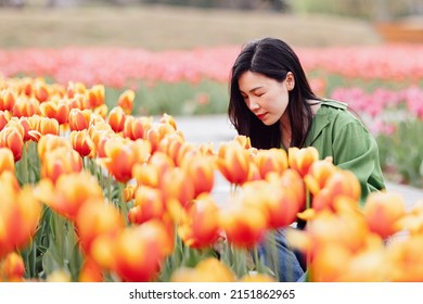 Candid Lifestyle Portrait Of Happy Young Beautiful Asian Sexy Woman Enjoying Life Outdoor In Park At Spring. Smiling Millennial Girl With Perfect Clear Glow Skin And Long Brunette Hair