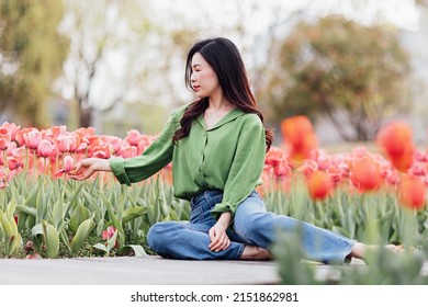 Candid Lifestyle Portrait Of Happy Young Beautiful Asian Sexy Woman Enjoying Life Outdoor In Park At Spring. Smiling Millennial Girl With Perfect Clear Glow Skin And Long Brunette Hair