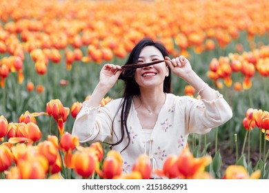 Candid Lifestyle Portrait Of Happy Young Beautiful Asian Sexy Woman Enjoying Life Outdoor In Park At Spring. Smiling Millennial Girl With Perfect Clear Glow Skin And Long Brunette Hair