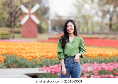 Candid Lifestyle Portrait Of Happy Young Beautiful Asian Sexy Woman Enjoying Life Outdoor In Park At Spring. Smiling Millennial Girl With Perfect Clear Glow Skin And Long Brunette Hair