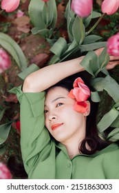 Candid Lifestyle Portrait Of Happy Young Beautiful Asian Sexy Woman Enjoying Life Outdoor In Park At Spring. Smiling Millennial Girl With Perfect Clear Glow Skin And Long Brunette Hair