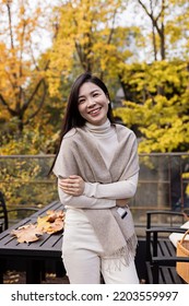 Candid Lifestyle Portrait Of Young Beautiful Asian Woman Smiling Outdoor At Autumn. Closeup Sexy Beauty Fashion Girl Having Fun At Fall.