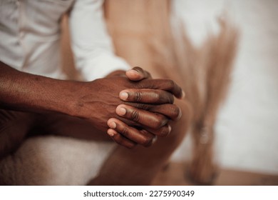 Candid millennial authentic diverse portrait of african american man relax time at apartment in neutrals tones colors interior. Domestic life multi ethnic male sitting at cozy home in day light - Shutterstock ID 2275990349