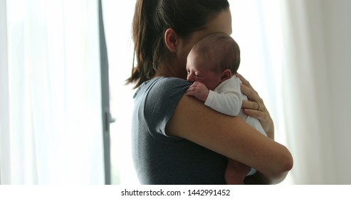 Candid Mom Holding Newborn Baby Hugging And Loving