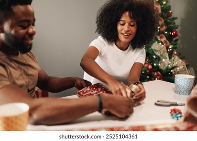 A candid moment capturing a joyous diverse couple sharing laughter while wrapping Christmas gifts together. The festive decorations in the background symbolize the holiday spirit. - Powered by Shutterstock