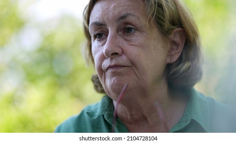 Candid Older Senior Woman Wearing Reading Glasses Outside Speaking