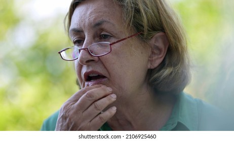 Candid Older Senior Woman Wearing Reading Glasses Outside Speaking