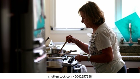 Candid Older Woman Cooking At Home