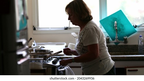 Candid Older Woman Cooking At Home