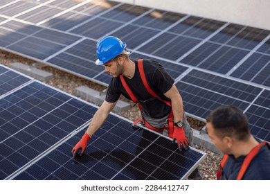 Candid photo of expert solar energy consultant on a roof installing solar panels, green energy and sustainable living, eco solutions, generative ai - Powered by Shutterstock