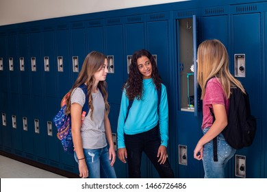 Candid photo of Three Junior High school Students talking together in a school hallway. Diverse Female school girls smiling and having fun together during a break at school - Shutterstock ID 1466726486