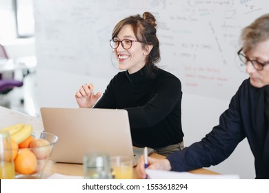 Candid Portrait Of Beautiful Female Marketing Expert Working On New Ideas Within Creative Team During A Meeting In Office.