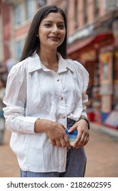 Candid portrait of a young beautiful Indian Nepali girl wearing white shirt
